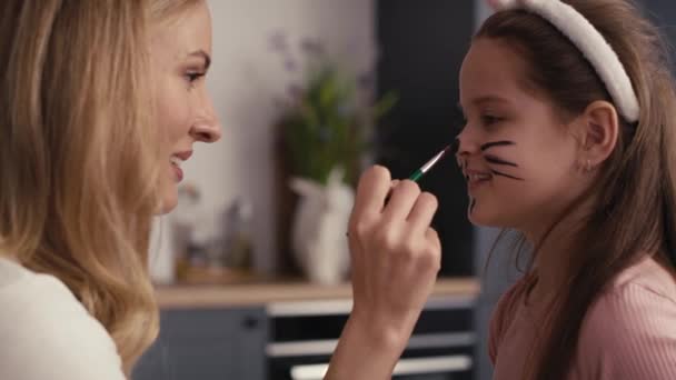 Side View Caucasian Mother Daughter Painting Easter Bunny Girl Face — Stock Video