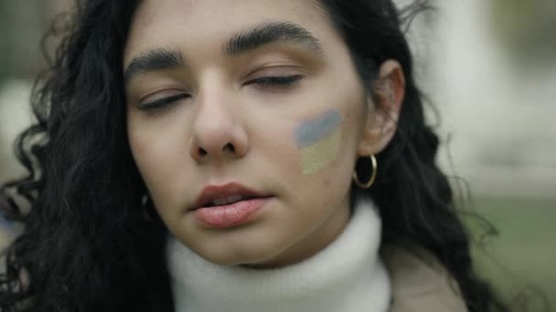 Zbliżenie Portret Młodej Kobiety Ukraińską Flagą Namalowaną Policzku Nakręcony Aparatem — Wideo stockowe