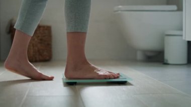 Banyo terazisine basan tanınmayan kadın bacakları. 8K 'da kırmızı helyum kamerayla çekildi.. 