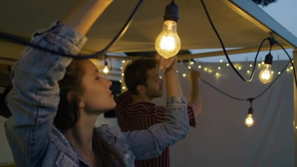 Young Couple Making Lights Decorations Camper Car Evening Shot Red — Stockvideo