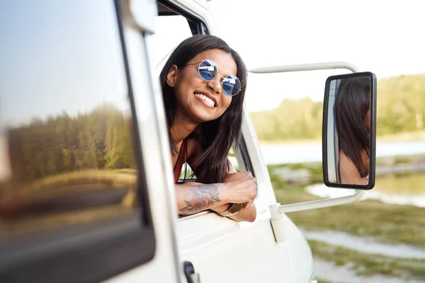 Cheerful Mixed Race Woman Sticking Out Camper Window Looking Camera — Zdjęcie stockowe