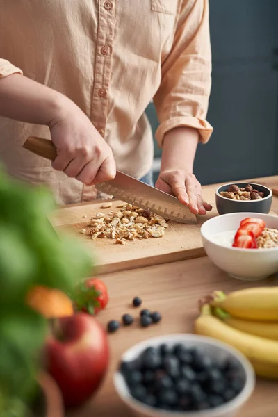 Woman Cutting Nuts Bowl Yogurt — Photo