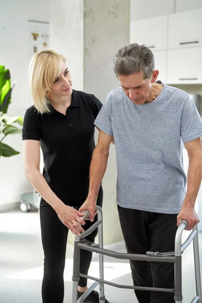 Senior Man Using Walker Assistance Nurse — стоковое фото
