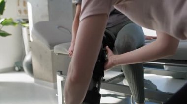 Caucasian woman with orthosis working with physical therapist. Shot with RED helium camera in 8K.