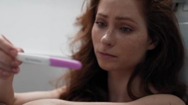 Caucasian woman in bathroom waiting for result of pregnancy test. Shot with RED helium camera in 4K.    