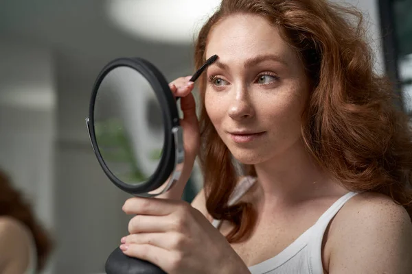 Caucasian Woman Brushing Eyebrows Mirror Reflection — 스톡 사진