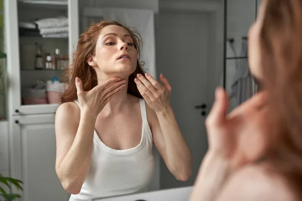 Redhead Woman Creaming Necks Reflection Mirror Bathroom — Stock Photo, Image