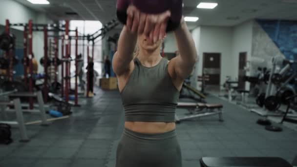 Young Caucasian Woman Exercising Kettlebells Gym Shot Red Helium Camera — стоковое видео