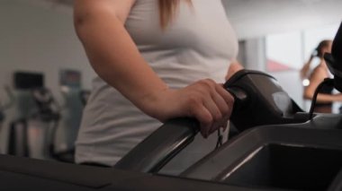 Aşırı kilolu, tanınmayan bir kadın spor salonunda antrenman yapıyor. 4K 'da kırmızı helyum kamerayla çekildi..   