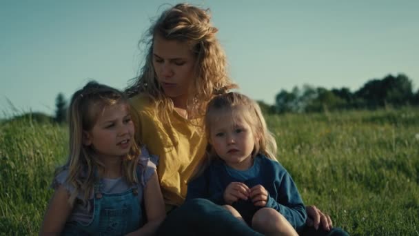 2人の娘とお母さんが結合し 牧草地で一緒に時間を過ごす 4KでRedヘリウムカメラで撮影 — ストック動画