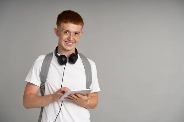 Ginger Male Student Using Digital Tablet Grey Background — Foto de Stock