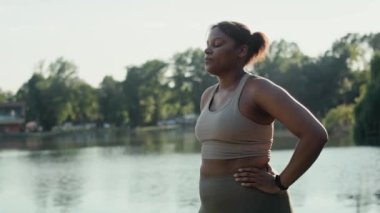 African American woman breathing after the running at the park  