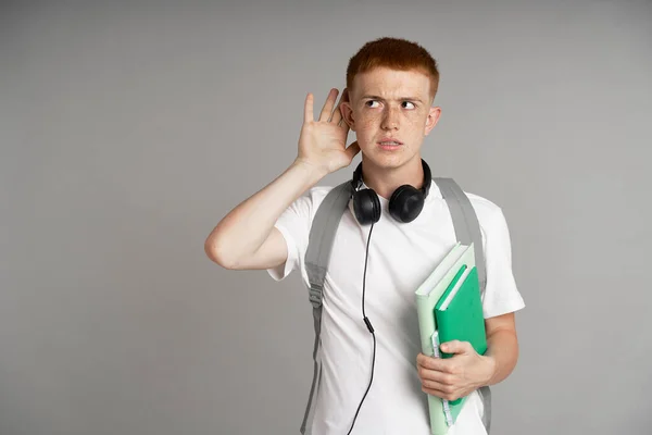 Ginger Young Boy Listening Something Studio Shot — Stockfoto