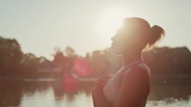 Afro-Amerikalı kadın parkta nefes egzersizi yapıyor. 8K 'da kırmızı helyum kamerayla çekildi..    