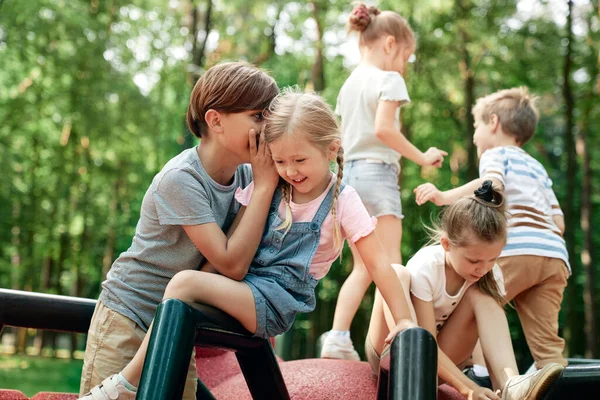 Caucasian Boy Telling Secret His Friend Playground — Stok fotoğraf