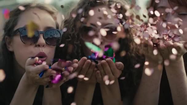 Three Young Caucasian Females Blowing Confetti Camera Later Dance Shot — Stock Video