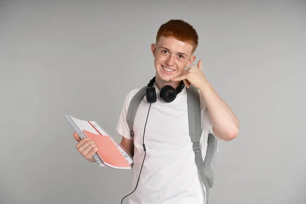 Redhead Teenage Boy Backpack Holding Books Showing Phone Sign Made — стоковое фото