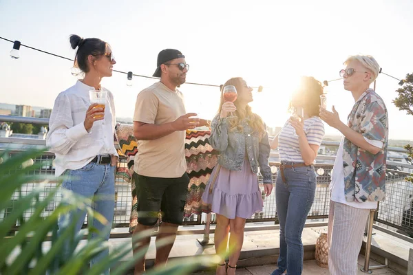 Group of multi ethnicity friends at the party in top of the roof