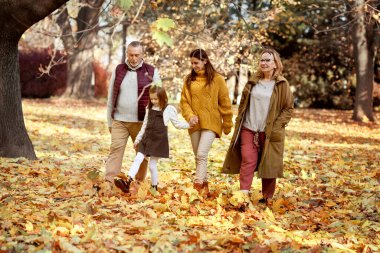 Family walking at the park in autumn 