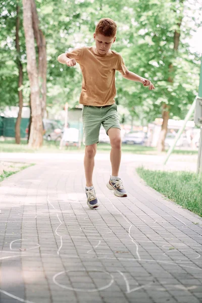 Ginger Boy Playing Hopscotch Summer Day — Stock fotografie
