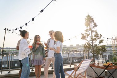 Group of young friends at the party in top of the roof 