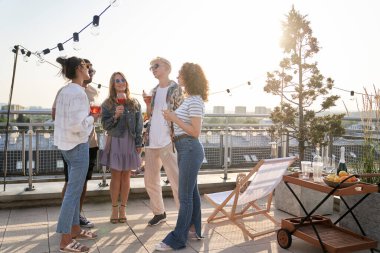 Group of young friends at the party in top of the roof 