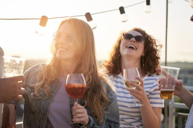 Group of young women at the party in top of the roof 
