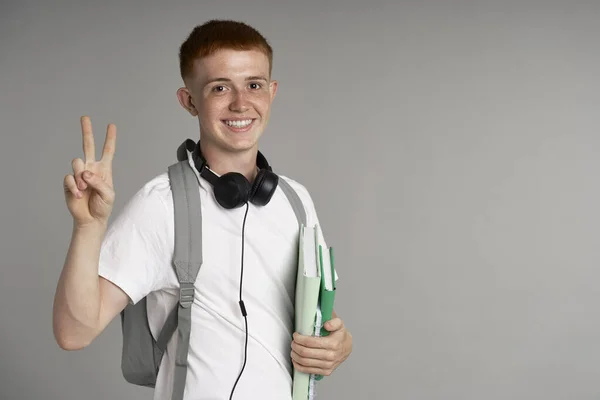 Redhead Teenage Boy Backpack Holding Books Showing Peace Sign Made — Stock fotografie