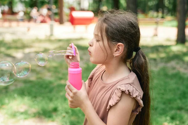 Caucasian Girl Blowing Soap Bubbles Park — Foto de Stock