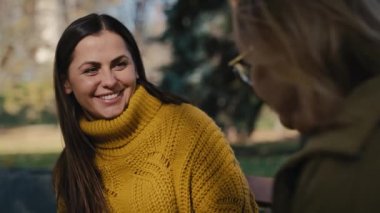 Close up caucasian woman talking with senior woman in park. Shot with RED helium camera in 4K