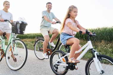 Caucasian family while bike ride in the woods