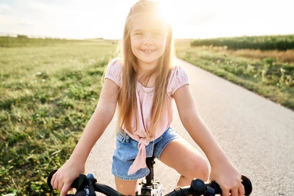 Portrait Little Caucasian Girl Sitting Bike Sunset Time — Fotografia de Stock