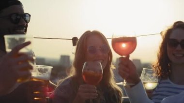 Group of friends make a toast at sunset in the city. Shot with RED helium camera in 8K. 