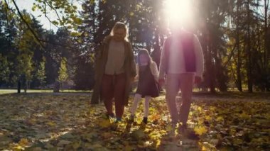 Senior caucasian couple with granddaughter walking in park together. Shot with RED helium camera in 4K    
