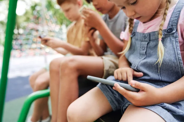 Group Kids Using Mobile Phone Playground — Stockfoto