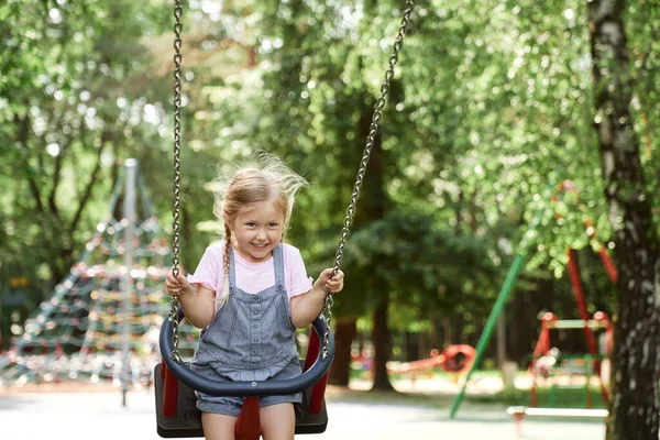 Caucasian Cute Little Girl Have Fun Swing Set — стоковое фото