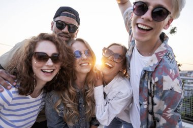 Portrait of group of multi ethnicity friends during the sunset