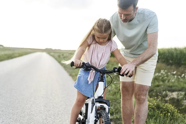 Father Teaching His Little Daughter How Ride Bike — Photo