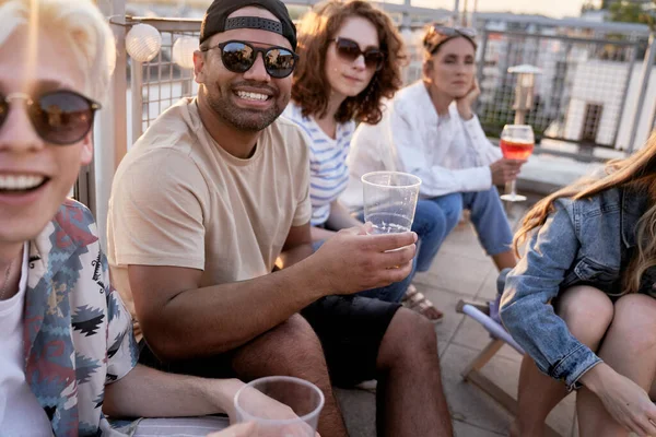 Group of friends have fun at the rooftop party in summer day
