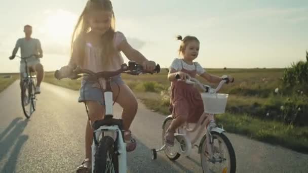 Caucasian Family Two Elementary Age Girls Foreground Parents Background Riding — Video