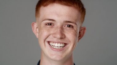 Close up portrait of red head caucasian teenage man with toothy smile. Shot with RED helium camera in 8K. 