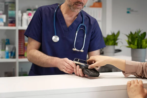 Close up of woman paying for visit at doctor