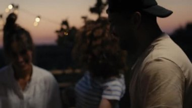 Group of friends dancing at the party in top of the roof. Shot with RED helium camera in 8K.  