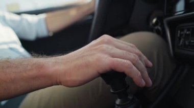 Close up of  hand of unrecognizable man changing gear in the car.  Shot with RED helium camera in 8K.