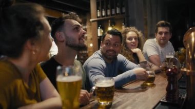 Group of friends spending time together in bar. Shot with RED helium camera in 8K. 