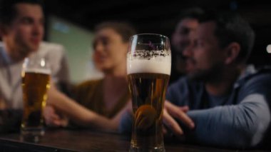 Close up of glass of beer in the bar. Shot with RED helium camera in 8K. 