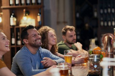 Group of friends spending time in bar together 