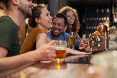 Caucasian group of friends have fun in the bar