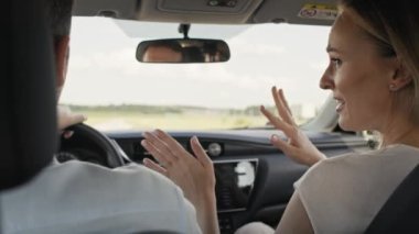 Back view of cheerful caucasian of middle age couple during a car trip. Shot with RED helium camera in 8K.