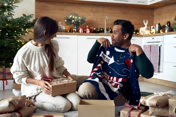Multi Ethnicity Couple Opening Christmas Presents Home — Fotografia de Stock